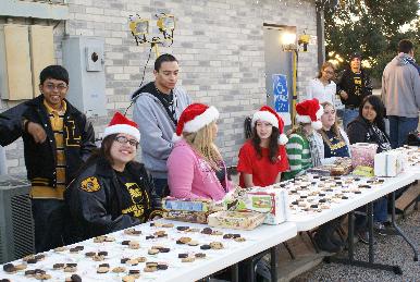 People in Santa hats sitting at a table